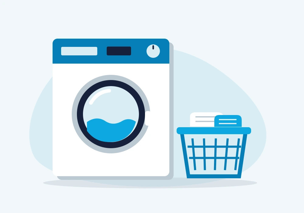 Front-loading washing machine beside a laundry basket