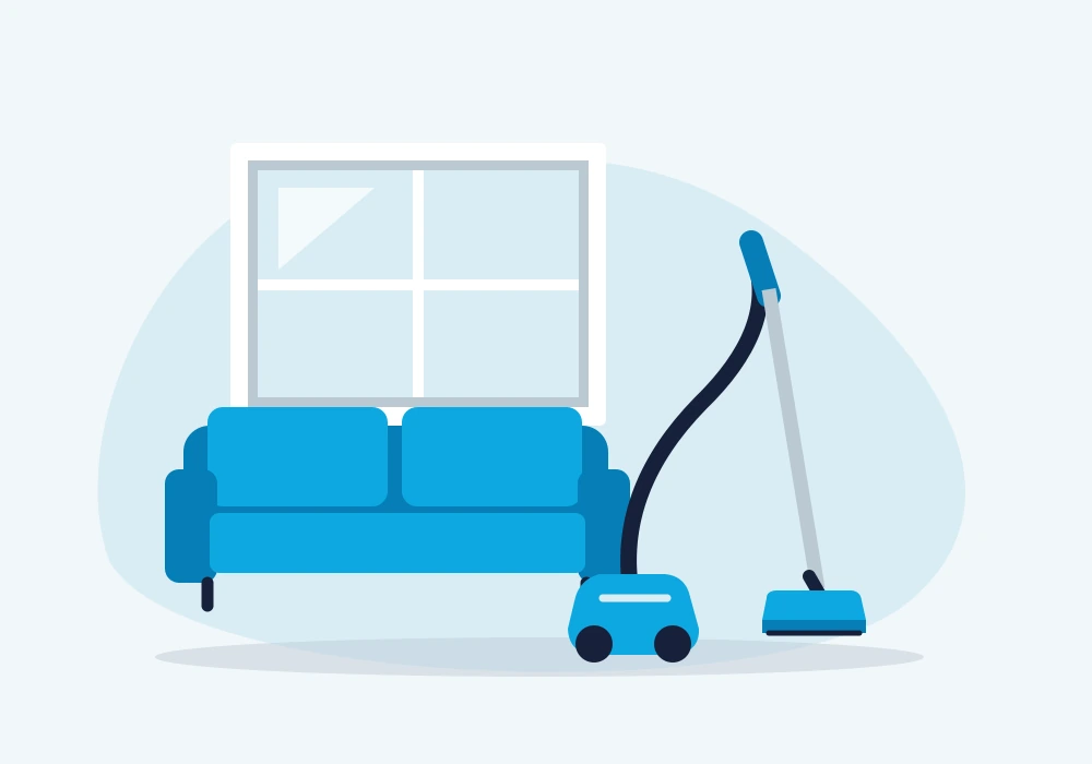 Canister vacuum cleaner beside a sofa