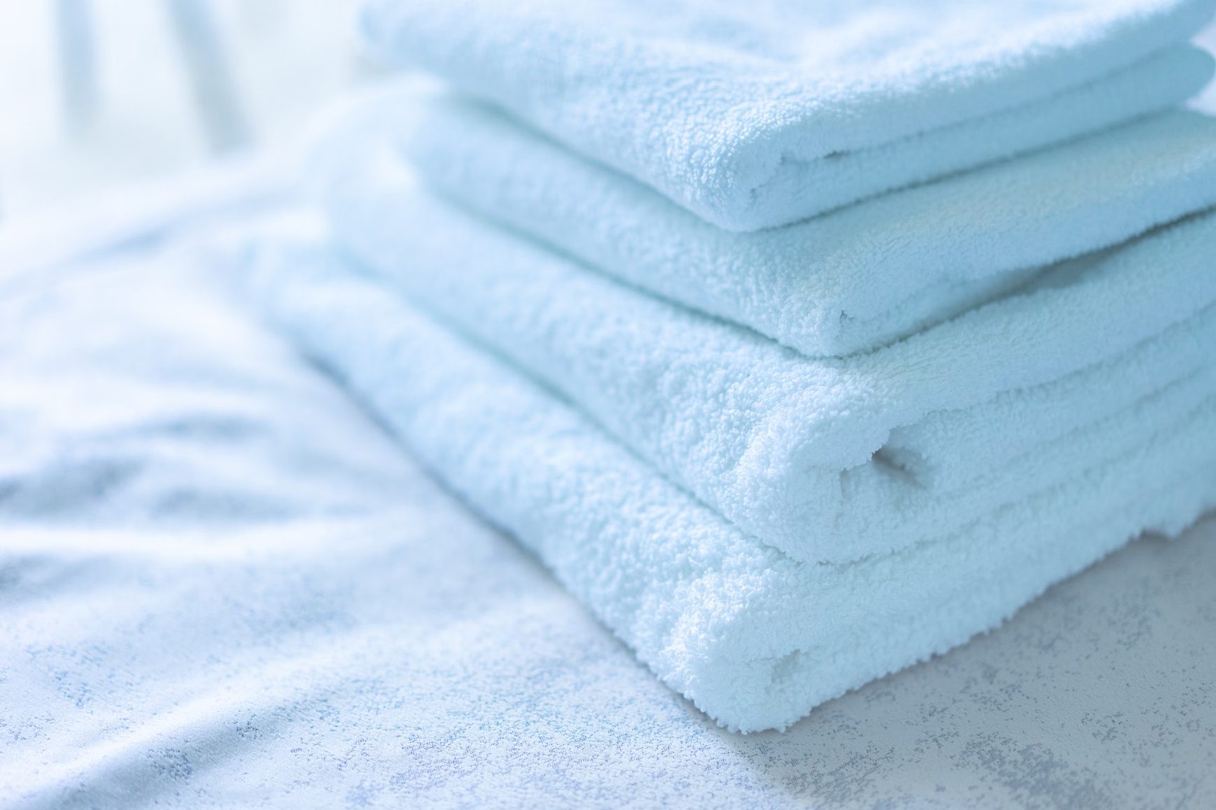 A neat stack of clean white cotton towels.
